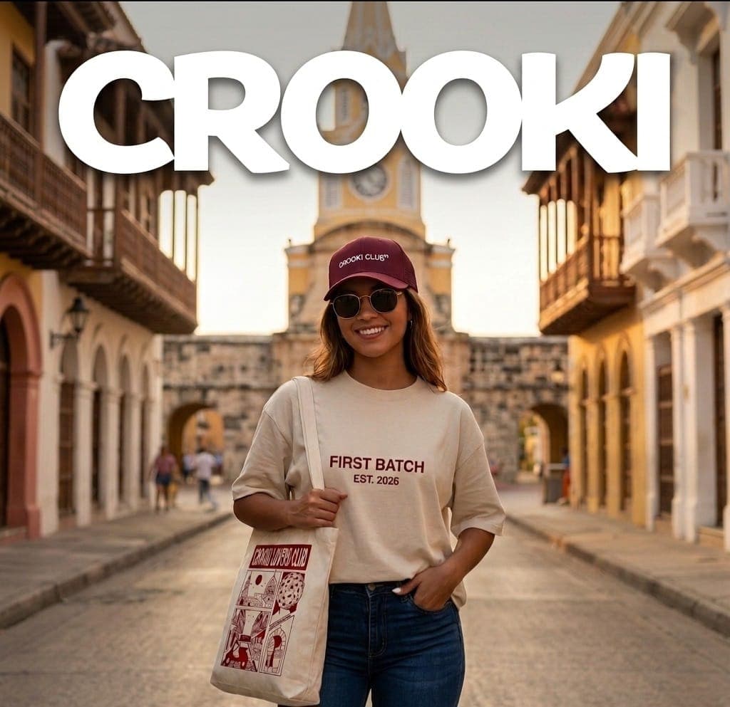 Woman wearing the Crooki Club cap, the First Batch tee and the Crooki Lovers Club tote bag in front of the Clock Tower in Cartagena